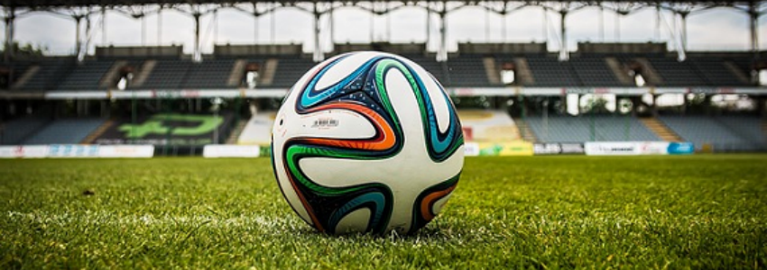 football on pitch in stadium